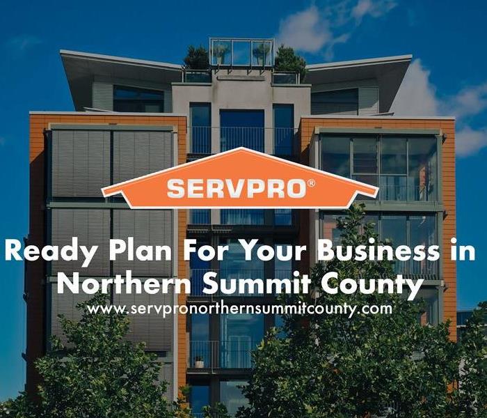 Orange SERVPRO  house logo on image with commercial building in the background